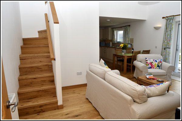 Smiddy:  Lounge and stairs to mezzanine bedroom with on-suite toilet
